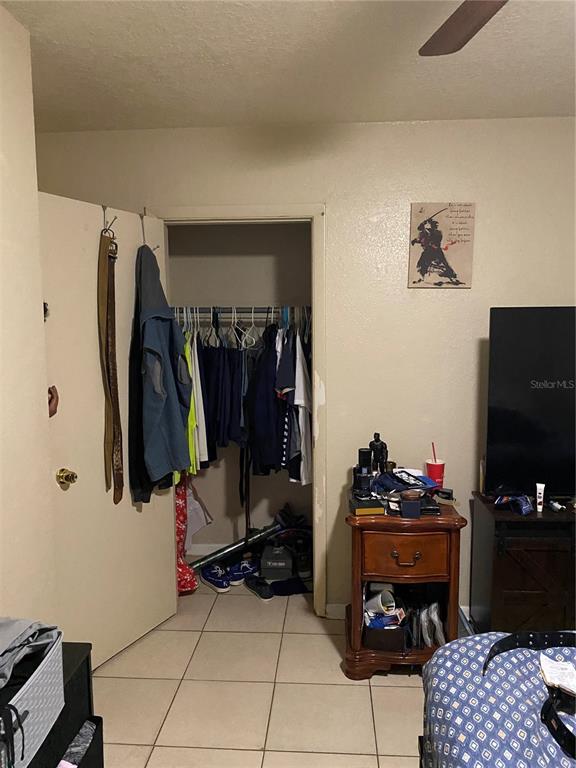 4207 Meadowbrook Avenue Orlando, FL 32808 - Photo 13 of 13 a room with gym equipment and a flat screen tv