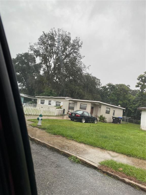 4207 Meadowbrook Avenue Orlando, FL 32808 - Photo 2 of 13 a view of a yard with wooden fence