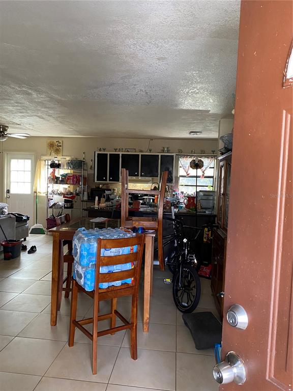 4207 Meadowbrook Avenue Orlando, FL 32808 - Photo 3 of 13 a room with furniture a flat screen tv and a window