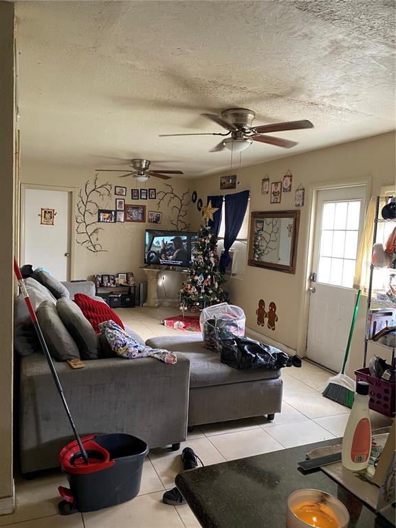 4207 Meadowbrook Avenue Orlando, FL 32808 - Photo 6 of 13 a living room with lots of furniture and a wooden floor