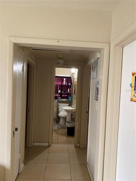 4207 Meadowbrook Avenue Orlando, FL 32808 - Photo 8 of 13 a view of a hallway and a livingroom with a furniture