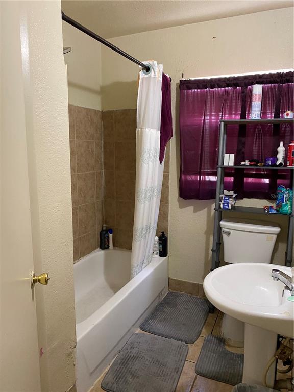 4207 Meadowbrook Avenue Orlando, FL 32808 - Photo 9 of 13 a bathroom with a sink toilet and shower