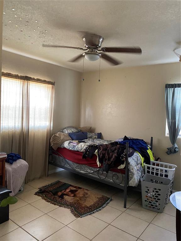 4207 Meadowbrook Avenue Orlando, FL 32808 - Photo 10 of 13 a living room with furniture and a chandelier