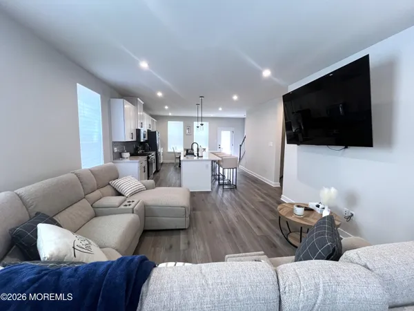 a living room with furniture window and wooden floor