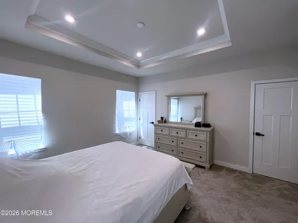a spacious bedroom with a bed and a table