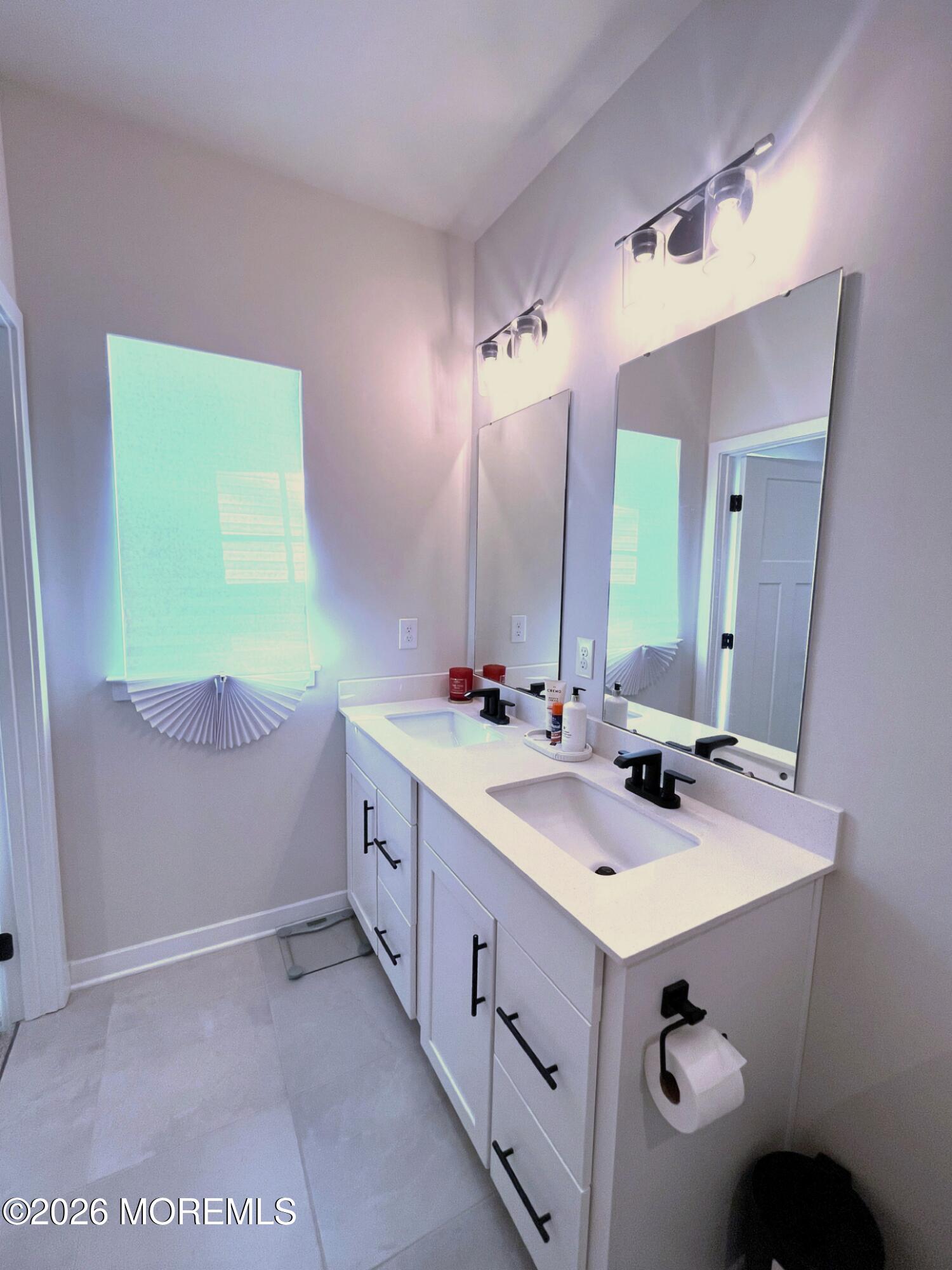 1 Halifax Road, Unit 1 Bayville, NJ 08721 - Photo 17 of 22 a bathroom with a double vanity sink and mirror