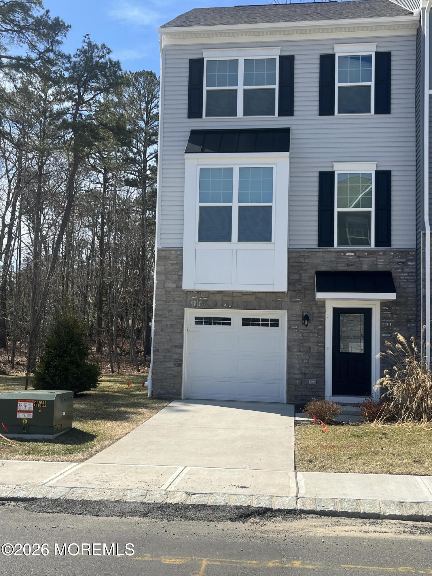 1 Halifax Road, Unit 1 Bayville, NJ 08721 - Photo 3 of 22 a front view of a house with a yard and garage