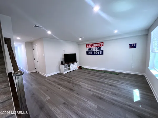 a bathroom with a sink a toilet a mirror and shower