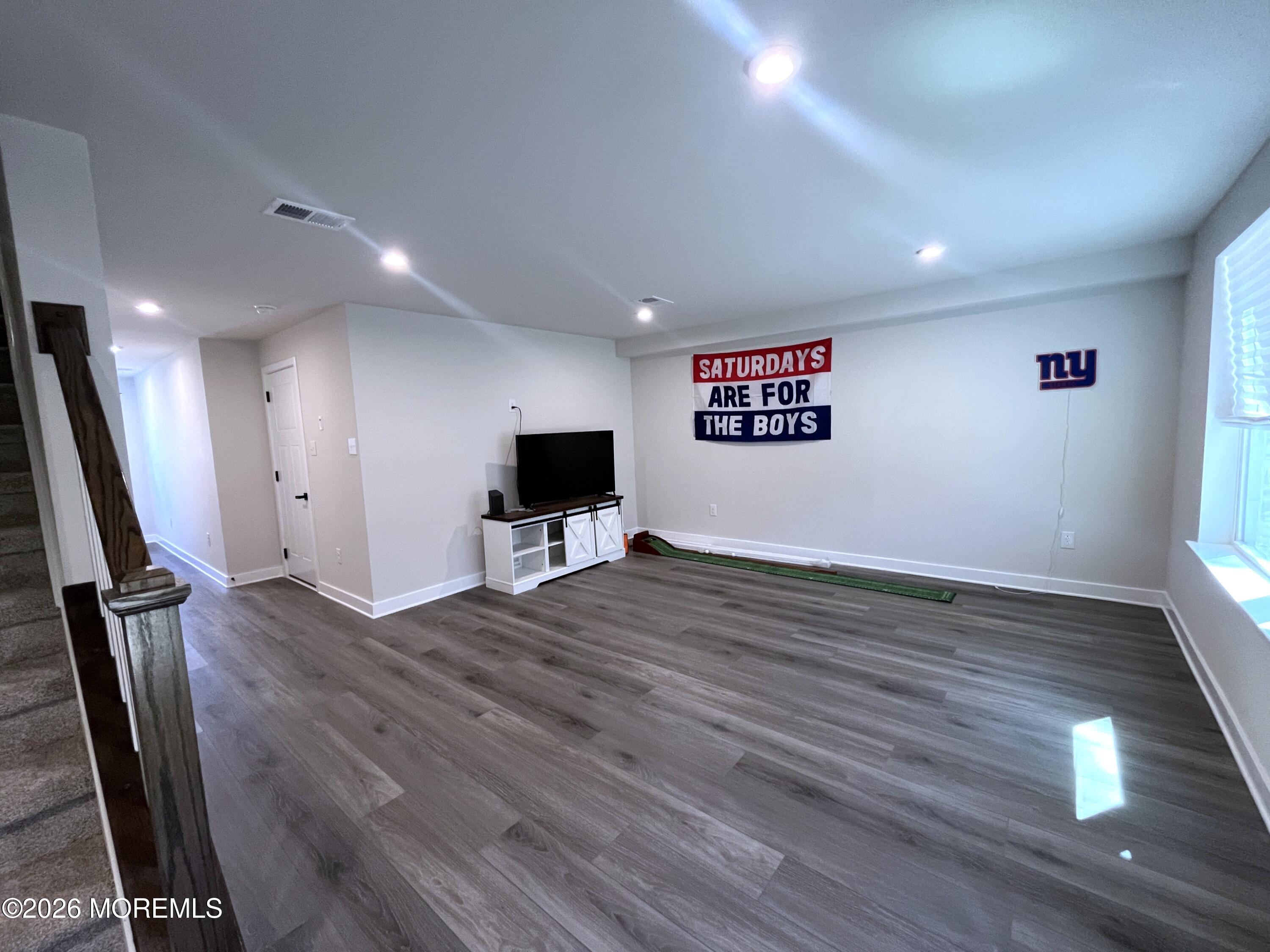 1 Halifax Road, Unit 1 Bayville, NJ 08721 - Photo 8 of 22 a view of empty room with wooden floor and fan