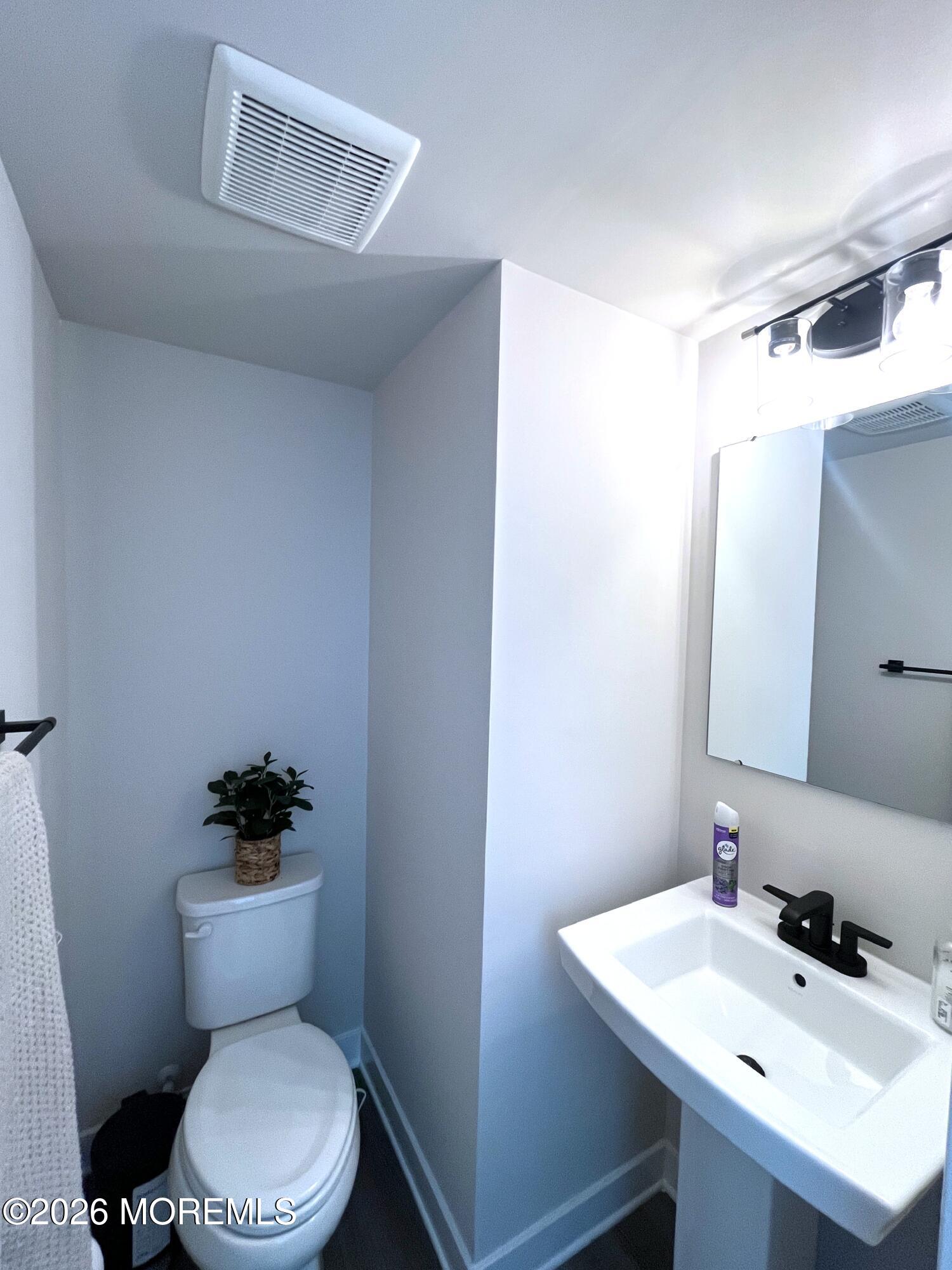 1 Halifax Road, Unit 1 Bayville, NJ 08721 - Photo 9 of 22 a bathroom with a sink a toilet a mirror and shower