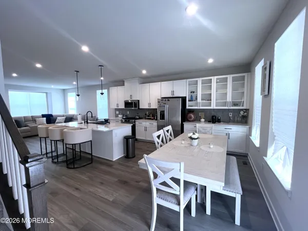 a kitchen with a sink stove and wooden floor