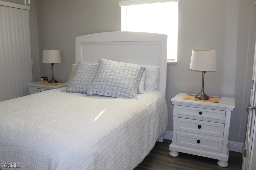 16881 Davis Road, Unit 112 Fort Myers, FL 33908 - Photo 9 of 15 a bedroom with a bed and a night stand