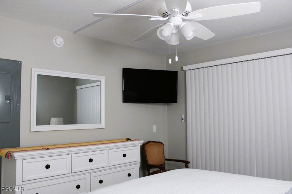 16881 Davis Road, Unit 112 Fort Myers, FL 33908 - Photo 10 of 15 a bedroom with a bed and a flat tv screen on dresser