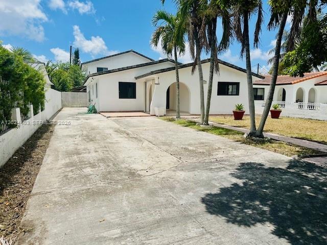 11870 Southwest 5th Street, Unit 1 Miami, FL 33184 - Photo 2 of 38 a view of a white house with a yard and palm trees