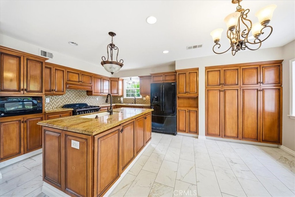 6481 Dos Rios Road Downey, CA 90240 - Photo 5 of 27 a kitchen with stainless steel appliances granite countertop a sink and a refrigerator