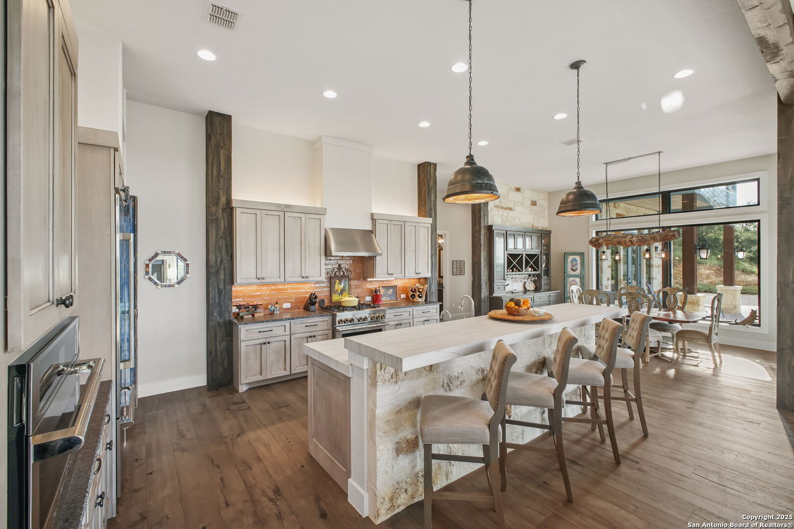 1023 Comanche Ridge New Braunfels, TX 78132 - Photo 15 of 109 a view of a dining room and livingroom with furniture wooden floor a chandelier