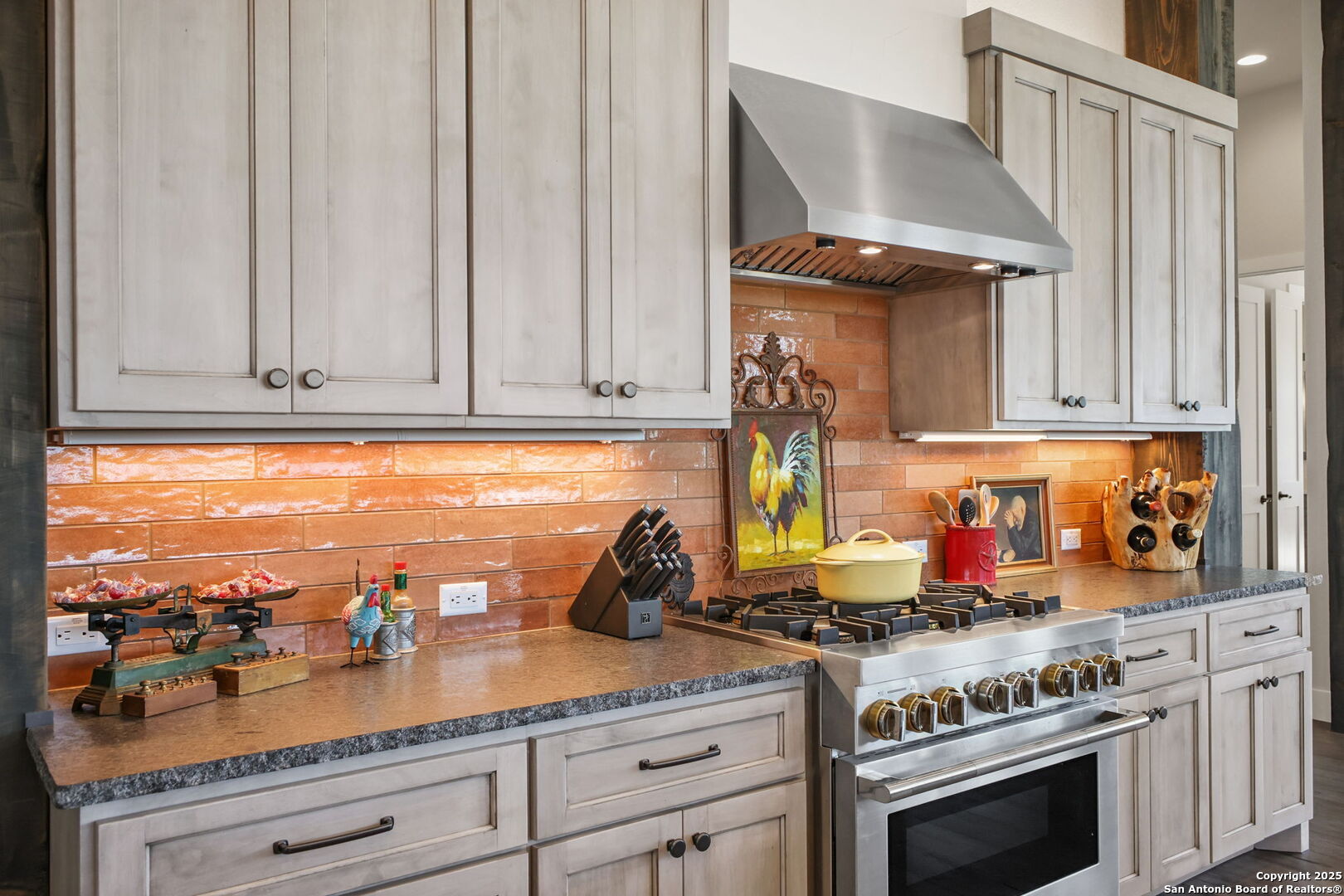 1023 Comanche Ridge New Braunfels, TX 78132 - Photo 17 of 109 a kitchen with granite countertop stainless steel appliances stove and sink