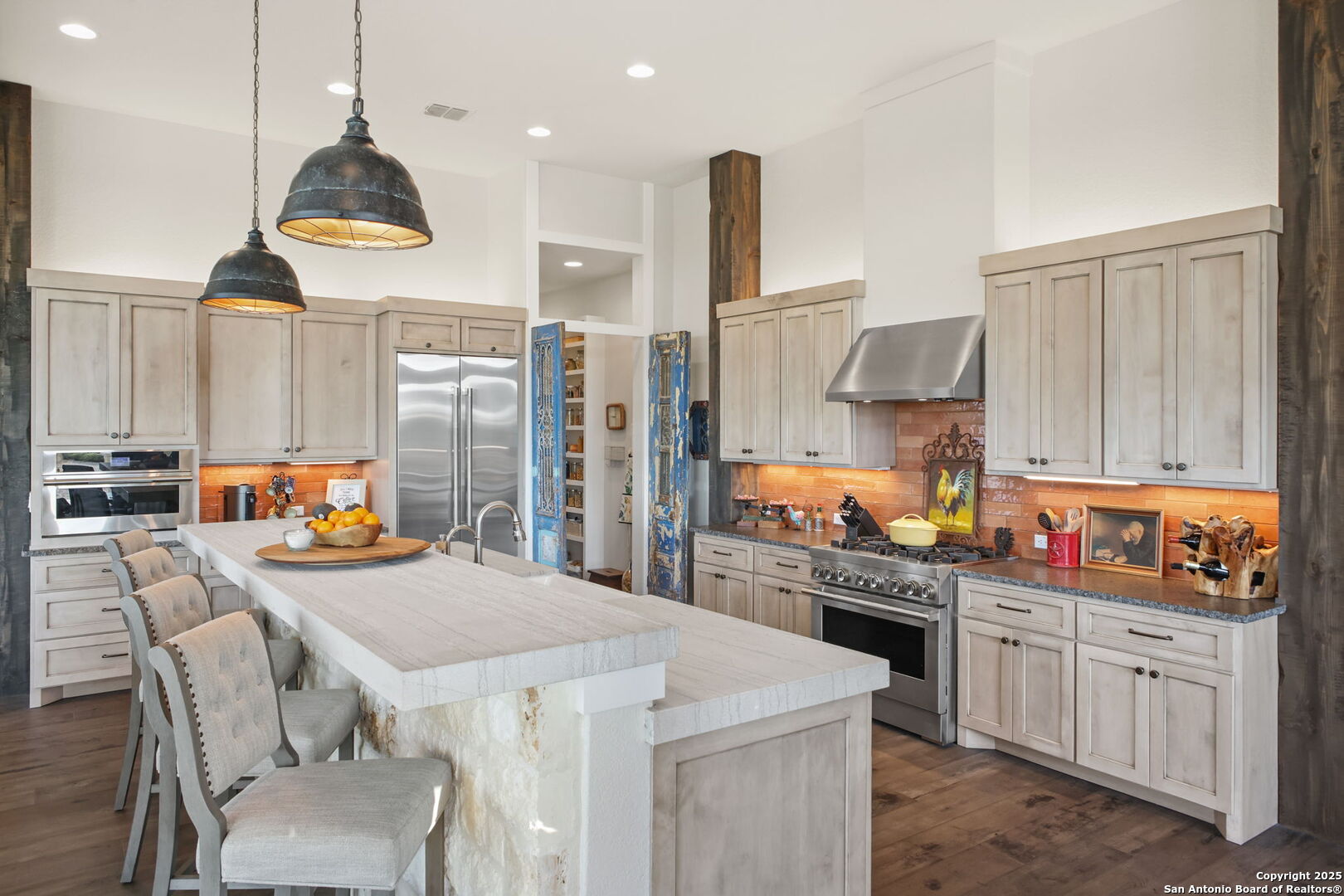 1023 Comanche Ridge New Braunfels, TX 78132 - Photo 20 of 109 a kitchen with stainless steel appliances kitchen island granite countertop a table chairs in it and a window