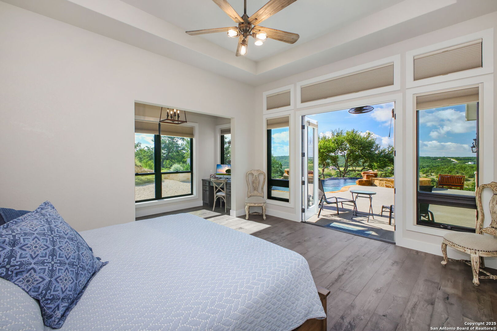 1023 Comanche Ridge New Braunfels, TX 78132 - Photo 31 of 109 a spacious bedroom with a large bed and a large window with outer view