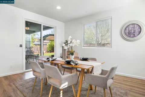 a dining room with furniture and a window
