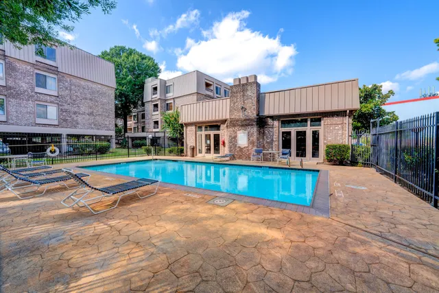 a view of a house with swimming pool and a yard