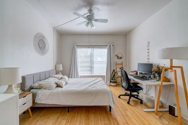 a bedroom with a bed and a desk
