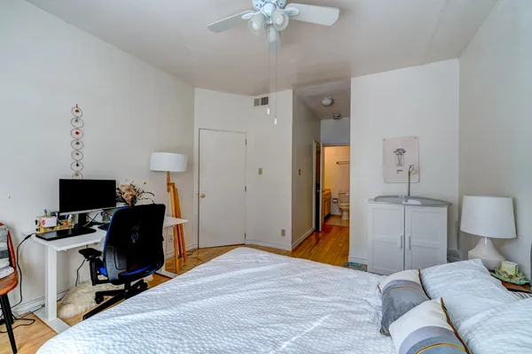 a bedroom with a bed and a chandelier