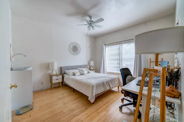 a bedroom with a bed and wooden floor