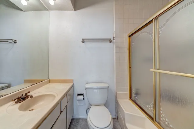 a bathroom with a toilet sink and shower