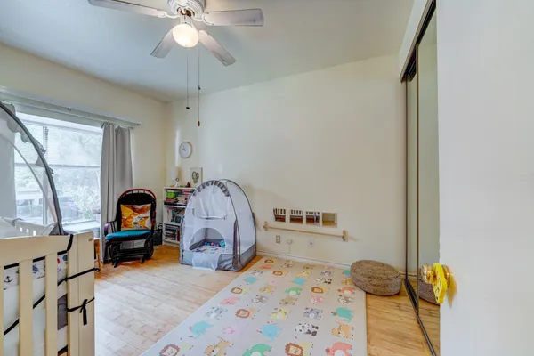 a bedroom with furniture and wooden floor