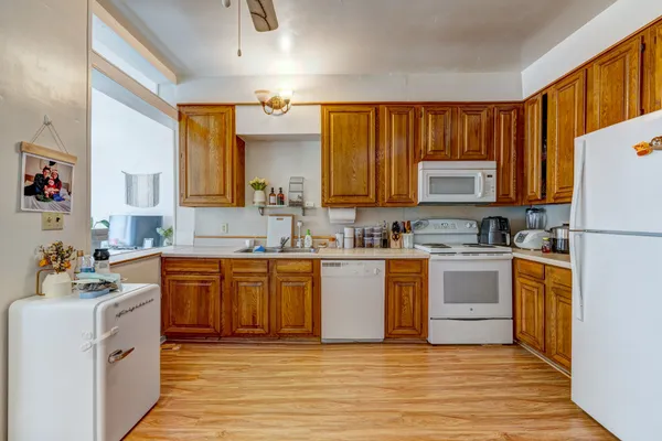 a large kitchen with stainless steel appliances granite countertop a stove a sink dishwasher and a refrigerator