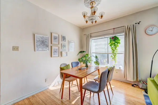 a view of a dining room with furniture window and wooden floor