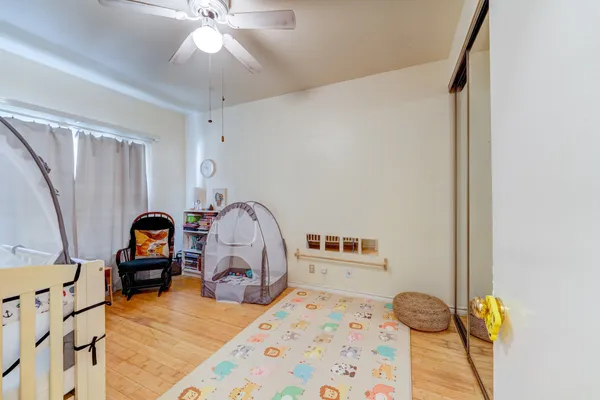 a bedroom with furniture and wooden floor