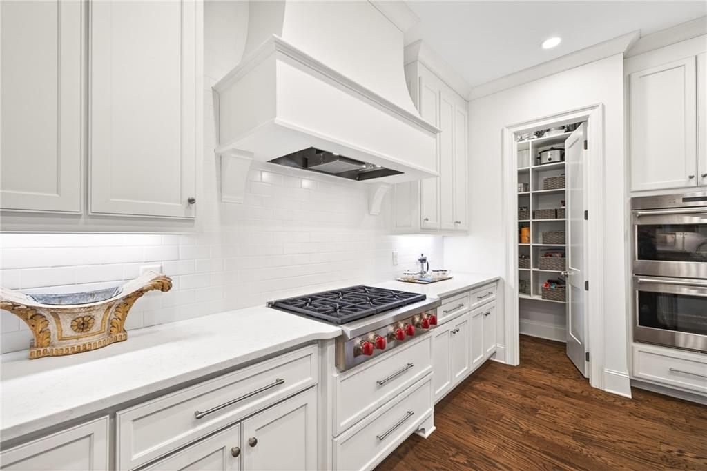 4774 Wieuca Road Northeast Atlanta, GA 30342 - Photo 13 of 52 a kitchen with stainless steel appliances granite countertop a stove and a refrigerator