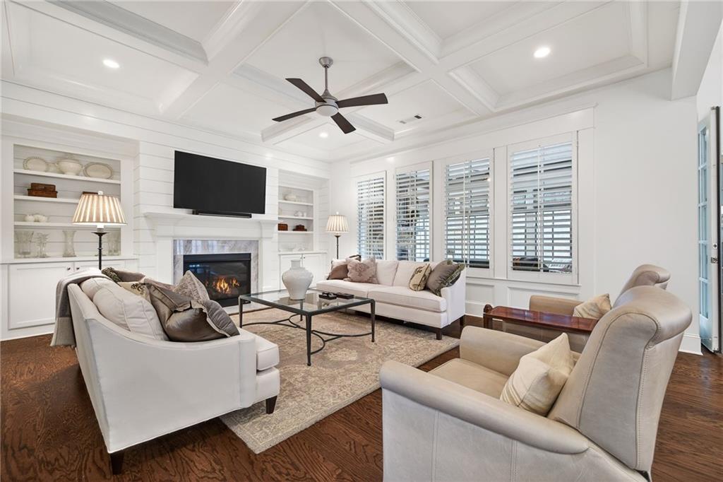 4774 Wieuca Road Northeast Atlanta, GA 30342 - Photo 20 of 52 a living room with furniture a fireplace and a flat screen tv