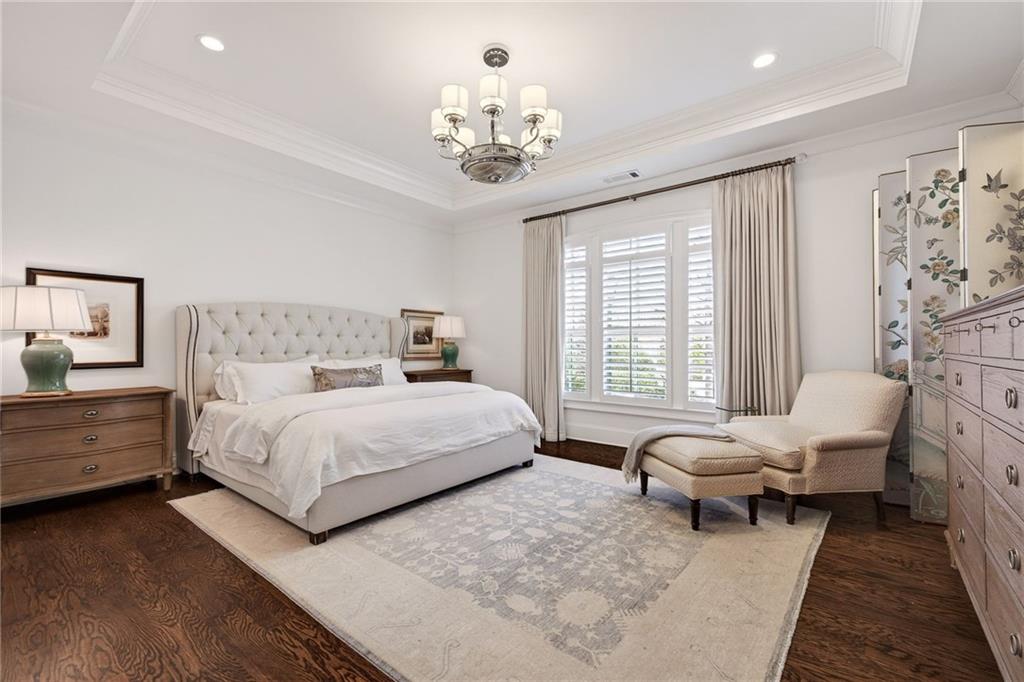 4774 Wieuca Road Northeast Atlanta, GA 30342 - Photo 22 of 52 a spacious bedroom with a bed and a chandelier