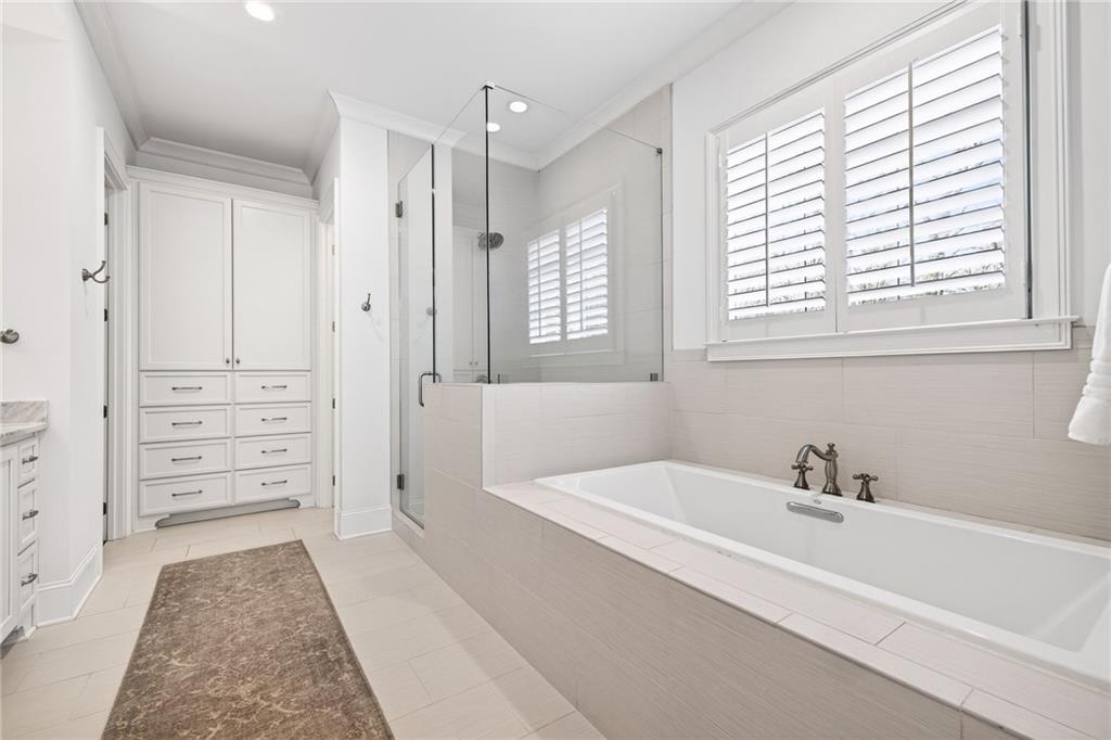 4774 Wieuca Road Northeast Atlanta, GA 30342 - Photo 24 of 52 a bathroom with a bathtub and a shower