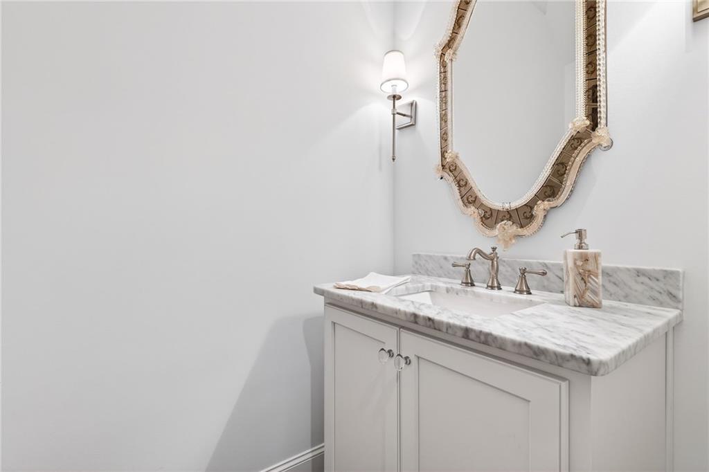 4774 Wieuca Road Northeast Atlanta, GA 30342 - Photo 28 of 52 a bathroom with a granite countertop sink and a mirror