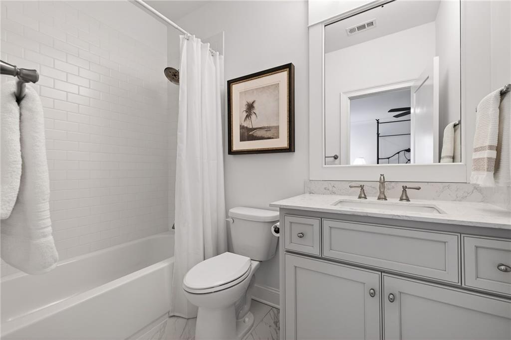 4774 Wieuca Road Northeast Atlanta, GA 30342 - Photo 35 of 52 a bathroom with a toilet a sink a bath tub and a mirror