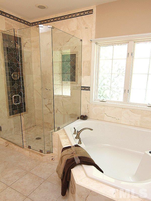 8718 Harps Mill Road Raleigh, NC 27615 - Photo 9 of 22 Updated Master Bathroom complete with Tiled Shower, Soaking Tub and Dual Vanities. Includes New Toilet.