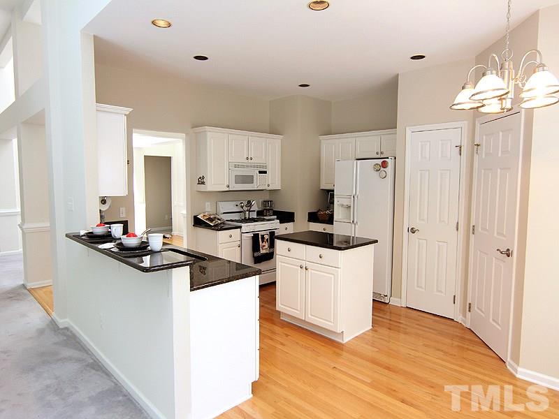 8718 Harps Mill Road Raleigh, NC 27615 - Photo 5 of 22 Open Kitchen with Bar Stool Console for Casual Eating and Entertaining.