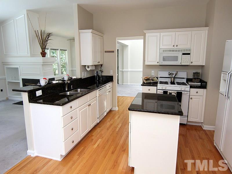 8718 Harps Mill Road Raleigh, NC 27615 - Photo 6 of 22 A Chef's Delight in this Spacious Kitchen. Offers Granite Countertops, 42" Cabinets and Center Kitchen Island.