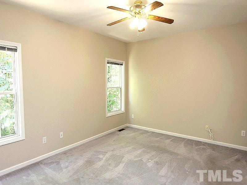 8718 Harps Mill Road Raleigh, NC 27615 - Photo 8 of 22 Master Bedroom with Ceiling Fan and View of the Backyard.