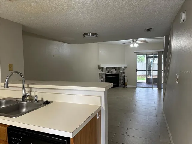 a kitchen with a sink a stove and cabinets