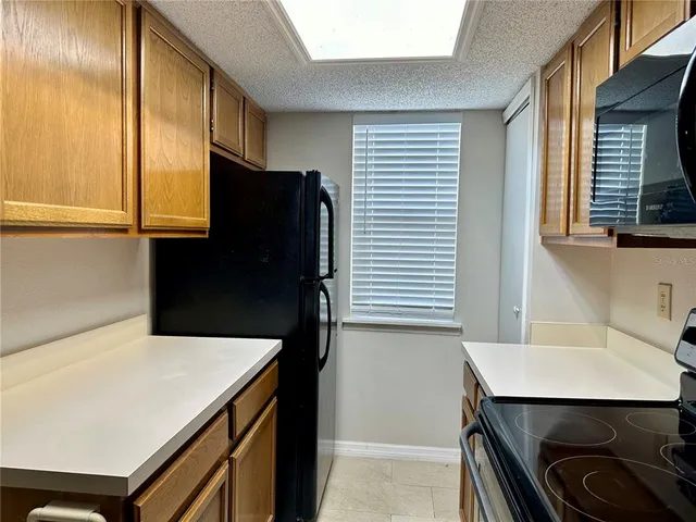 a kitchen with a wooden floor and cabinets