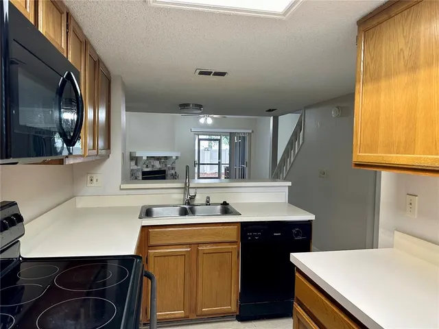 a kitchen with a sink cabinets and window
