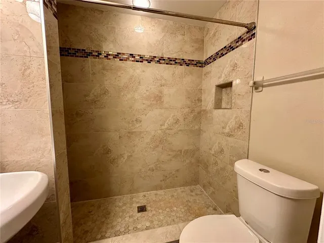 a bathroom with a toilet and a shower