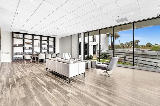a living room with furniture a rug and white walls