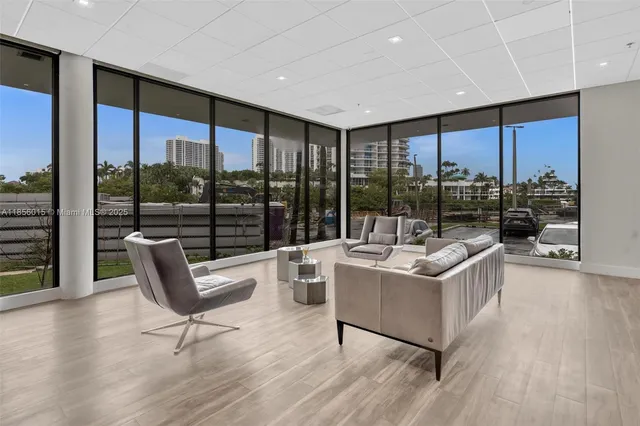 a dining room with furniture and a floor to ceiling window