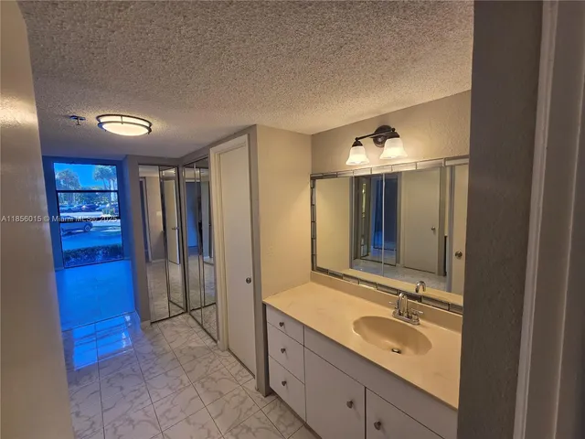 a spacious bathroom with a double vanity sink and a mirror